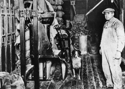 David Geiger and Mickey inside the mill by the flour packer